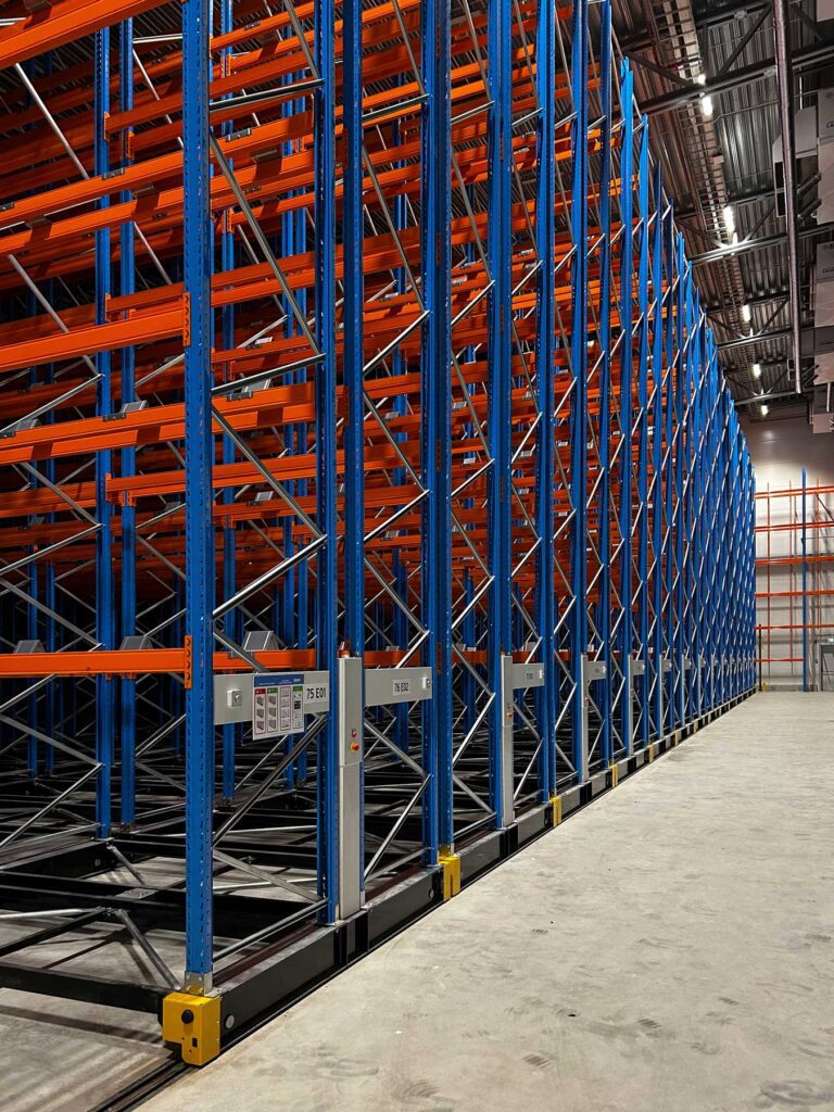 Mobile racking system creating high-density pallet storage inside a freezer warehouse environment